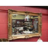 A rectangular bevelled edge wall hanging mirror, gilt gesso frame,