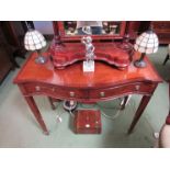 A reproduction mahogany serpentine front side table with two drawers,