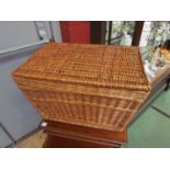 A wicker twin handled picnic basket