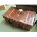 A vintage brown leather travelling trunk with original straps and key