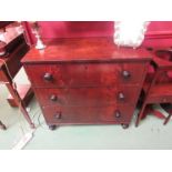 A 19th flamed mahogany chest of three long drawers over turned feet