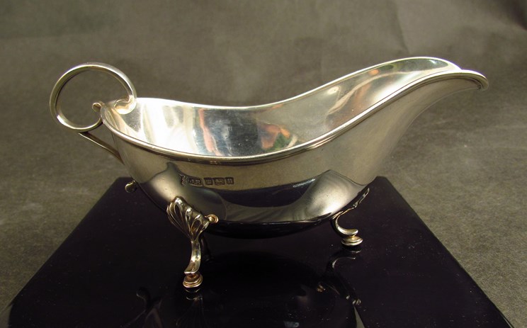 A Joseph Rodgers and Sons silver sauce boat on shell and hoof feet, Sheffield 1905,