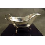 A Joseph Rodgers and Sons silver sauce boat on shell and hoof feet, Sheffield 1905,