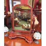 A Victorian mahogany table top mirror with serpentine base