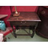 An 18th style oak side table the single frieze drawer over turned legs joined by stretchers