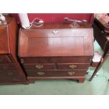 A Georgian oak two drawer over single drawer bureau,