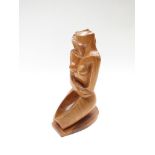 A carved wooden sculpture of a stylised naked woman, mid 20th Century,