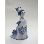 A Bjorn Wiinblad Danish art pottery figurine of a woman with basket of flowers.