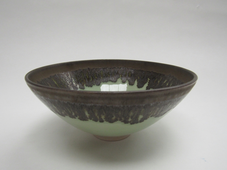 BILL MOORE (b1969) A studio porcelain bowl, green glaze with manganese rim. Impressed seal.