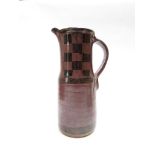 MICHAEL CASSON (1925-2003) A stoneware tall jug, rust glaze with tenmoku checker board detail.