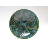 A Poole Studio bowl, green ground with blue abstract detail. Blue back stamp.