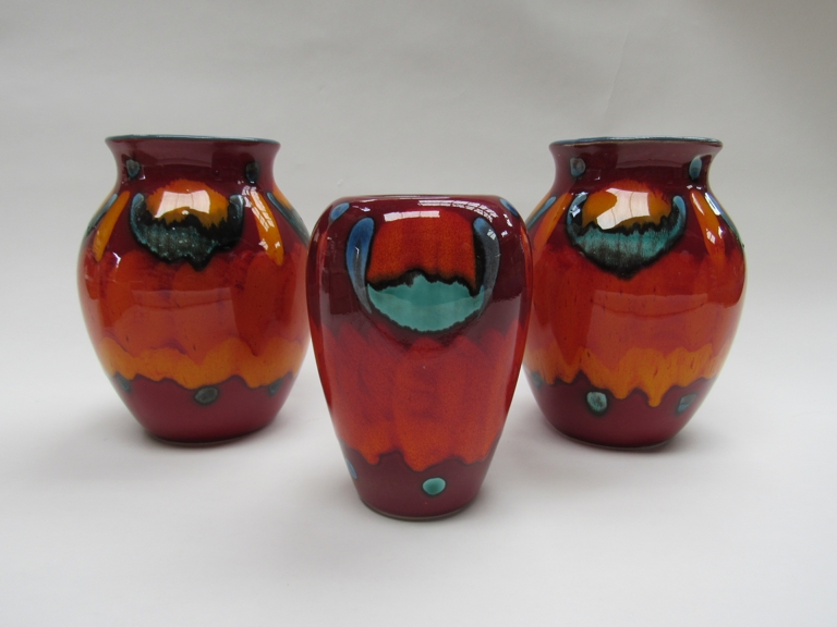 A pair of Poole Volcano range bulbous vases and another.