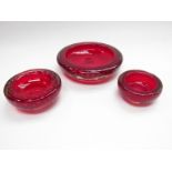 Three Whitefriars ruby graduating dishes with bubble inclusions largest 19cm diameter