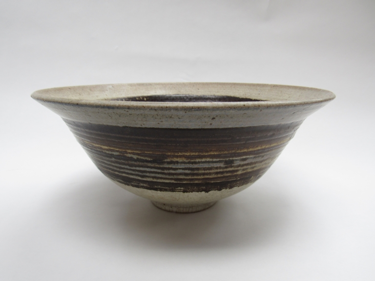 PETER LANE (b.1932) A studio pottery bowl, flared form. Tenmoku band glaze. Incised marks to base.