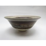 PETER LANE (b.1932) A studio pottery bowl, flared form. Tenmoku band glaze. Incised marks to base.