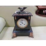 A late 19th Century Belgium black marble mantel clock with decorative enamel face raised on ormolu