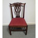 A George III mahogany chair with carved and pierced central splat