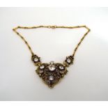 A Coro necklace with glass set floral scrolling linked pendant