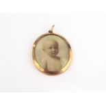 A miniature on ivory of young child with blonde hair in 9ct gold mount