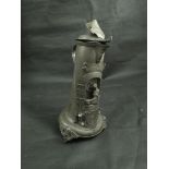 An 18th Century pewter stein depicting a blacksmith,