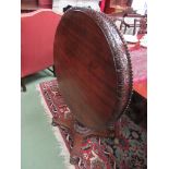 A 19th Century Colonial Anglo Indian Padouk table the circular snap top with a carved frieze and