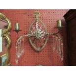 A pair of late Victorian brass and crystal wall sconces with embossed detail a/f