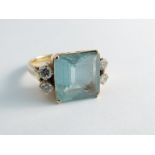 An aquamarine and diamond ring the large square cut aquamarine flanked by two brilliant cut