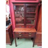 A George III mahogany bookcase on base the two glazed doors with key over two drawers on an