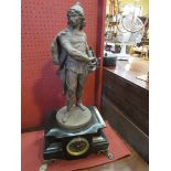 A late 19th Century French figural clock surmounted by gentleman with sword and shield,