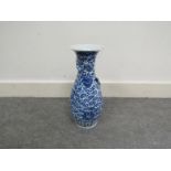 A 19th Century Oriental blue and white vase with circular floral rim above bulbous body,