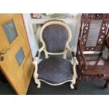 A French painted armchair with carved gilt relief decoration and pattern blue upholstery