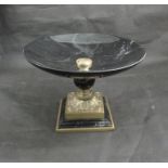 A black marble and brass table centrepiece with acanthus leaf design stepped base, 20cm tall,