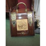 A Victorian oak and brass coal scuttle with scoop and tile set to lid depicting shepherdess and