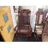 A circa 1840 carved oak bergere elbow chair carved crest with lion standing on a ball,