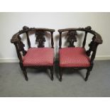 A pair of circa 1840 walnut corner chairs with carved acanthus leaf,