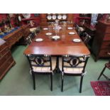 A 19th Century Georgian mahogany concertina action dining table with drop end flaps and two extra