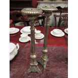 A pair of Victorian brass style altar sticks of column form, on flared bases,