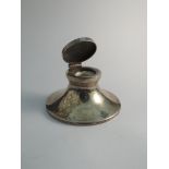 A silver Capstan inkwell with original liner, marks rubbed,