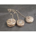 Three white and gilt metal filigree circular pomanders on chains