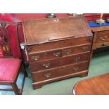 An early 18th Century oak bureau with hidden well, one handle missing,