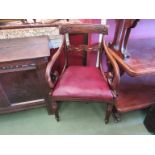 A William IV mahogany desk chair the carved back rest over scroll arms on turned and fluted legs