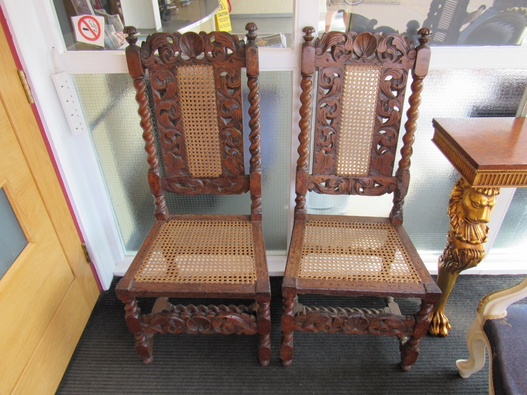 A pair of 18th Century & later carved walnut bergere chairs with barley twist supports and