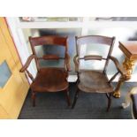 A pair of mid Victorian elm and beech knife back elbow chairs on turned legs joined by an H