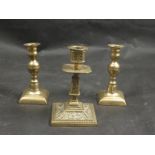A Victorian brass embossed candlestick and two others (3)