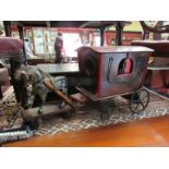 A late 19th/early 20th Century hand built toy Gypsy wagon and house with iron wheels with crest to