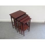 An Edwardian mahogany nest of four tables with satinwood line inlay