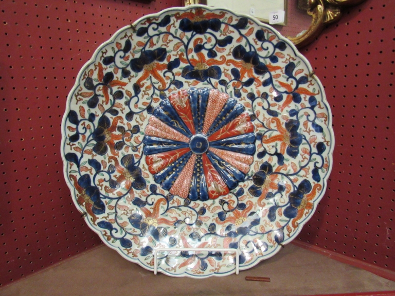 An early 19th Century Japanese Imari pattern charger, embossed Chrysanthemum to centre,