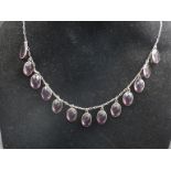 An amethyst drop necklace with 13 oval facetted cut stones