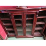 A circa 1860 oak breakfront bookcase the two glazed doors flanked by height adjustable shelves on a