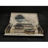 A lady's silver cased dressing table brush, mirror set in original case, (one brush slight dents,